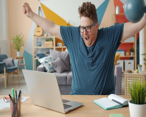 Person stretching arms at desk taking a screen break