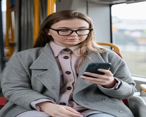 Person reading on a smartphone while commuting on a bus